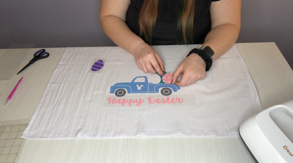 Lining up the egg to lay next to the center egg and in the dip in the truck bed