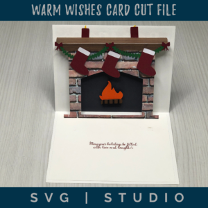 the inside of the warm wishes card is a pop up of a fireplace with a mantel with stockings and candles