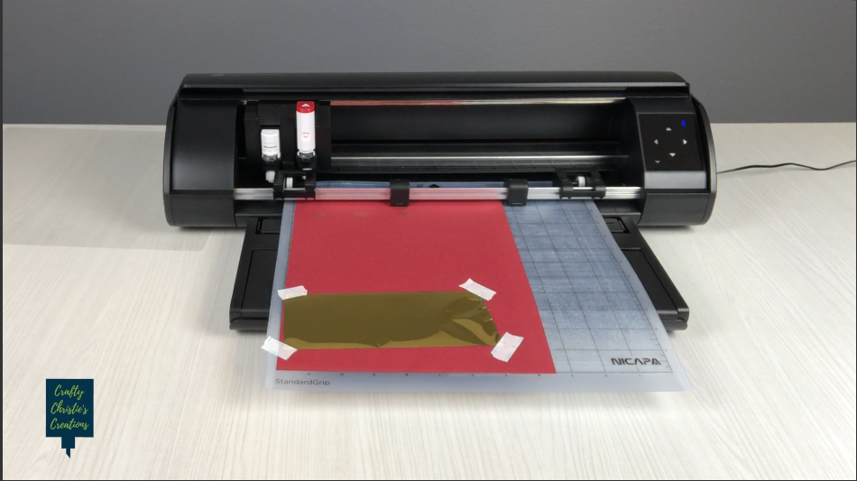 Adding vinyl to the base material on the cutting mat and loading into the machine
