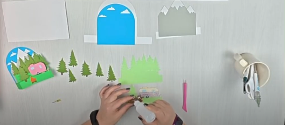 layering the camper, fire, and tree on the front panel for the box card